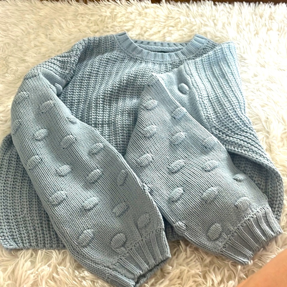 Light blue sweater with dots on sleeves